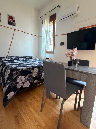 a bedroom with a bed and a desk with a table at Grazia's Heaven in Trezzo sullʼAdda