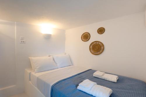 a bedroom with a bed with two towels on it at Silver Lining in Akrotiri