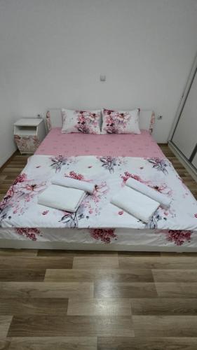 a bedroom with a bed with a pink comforter at Ceca & Dimi 2 in Gevgelija