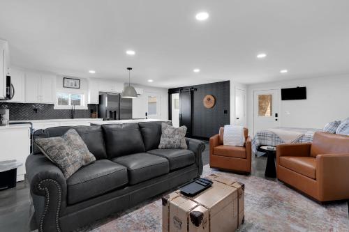 a living room with a leather couch and a living room with a couch at Lounges at Lynchburg in Lynchburg