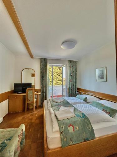 a bedroom with a large bed and a window at Porto MarIn Strašek in Portorož