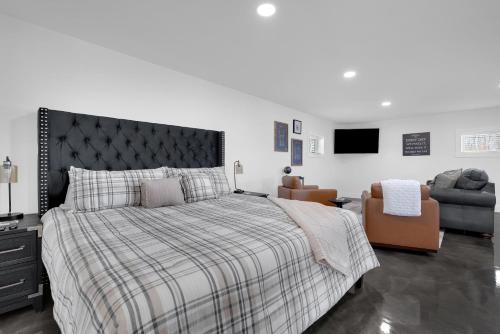 a bedroom with a large bed and a chair at Lounges at Lynchburg in Lynchburg