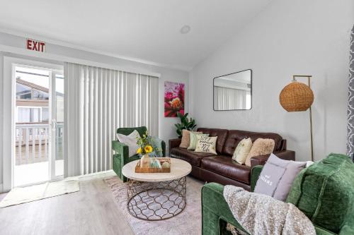 a living room with a couch and a table at Endless Sunset- Near Beach Surf and Pet Friendly in Huntington Beach