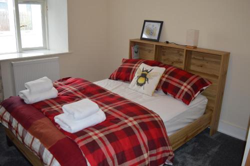 a bedroom with a bed with two towels on it at Number 2 in Montrose