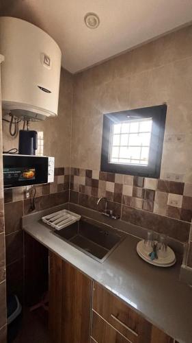 a kitchen with a sink and a window at Havre de paix in Dakar
