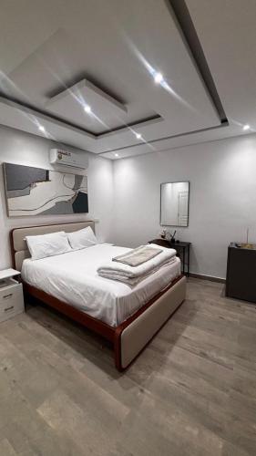 a bedroom with a large bed and a tv at Havre de paix in Dakar