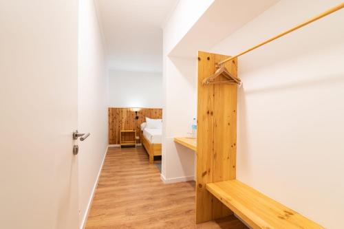 a room with a bed and a door to a bedroom at Vila Rosario in Ponta Delgada