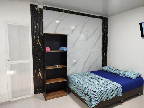 a bedroom with a bed with a wall at Apartaestudio Marbella #2-10 in Cartagena de Indias