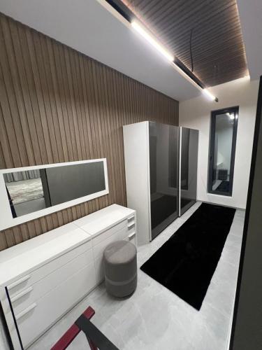 a bathroom with a white cabinet and a black rug at محمد هوم in Al Hofuf