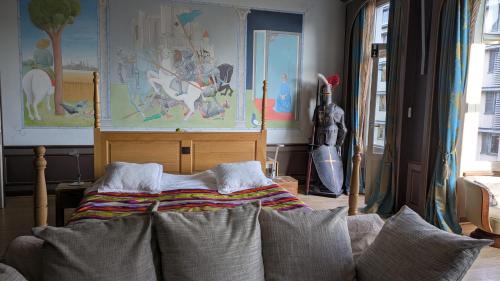 a bedroom with a bed and a painting on the wall at Guesthouse PPP in Ghent
