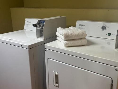 a pile of towels sitting on top of a washing machine at Days Inn by Wyndham Lake City I-10 in Lake City
