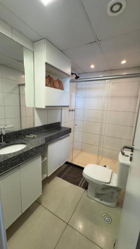 a bathroom with a toilet and a sink at Jam flats beira mar Olinda in Olinda