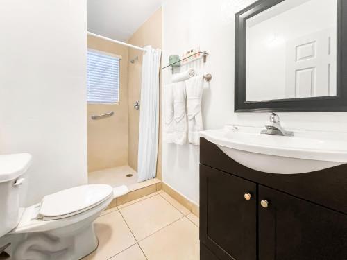 a bathroom with a sink and a toilet and a shower at Hollywood Broadwalk Oceanside Hotel in Hollywood