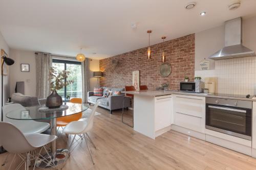 a kitchen and living room with a table and chairs at Lancaster City Apartment in Lancaster