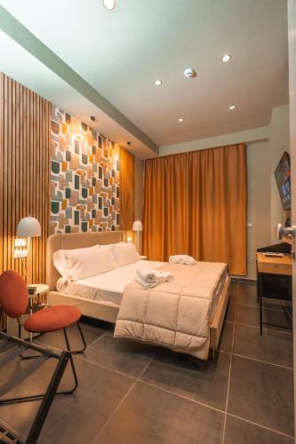 a bedroom with a bed and a table and a desk at Noah Gate Hotel & Suites in Naples
