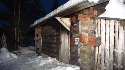 a small building with snow on top of it at Toola-Lodge in Syöte
