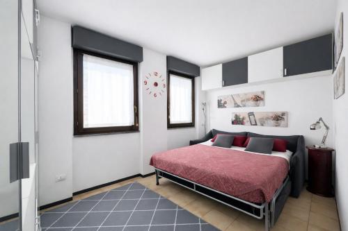 a bedroom with a bed with a red blanket at Bella Vita Stays Cozy in Sondrio