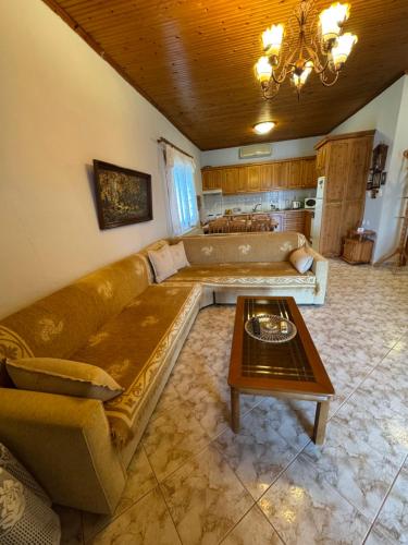a living room with a couch and a table at Pansedon House by the sea in Nea Kallikrateia