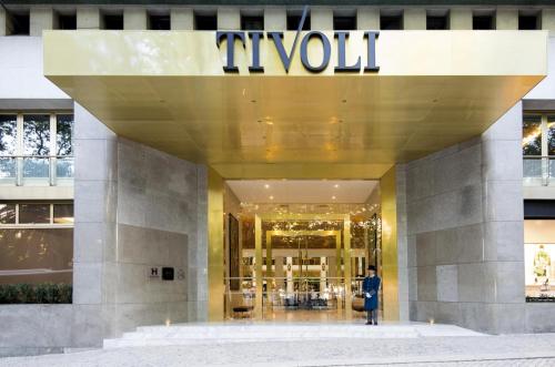 a man standing in front of a luxury store at Tivoli Avenida Liberdade Lisboa – A Leading Hotel of the World in Lisbon