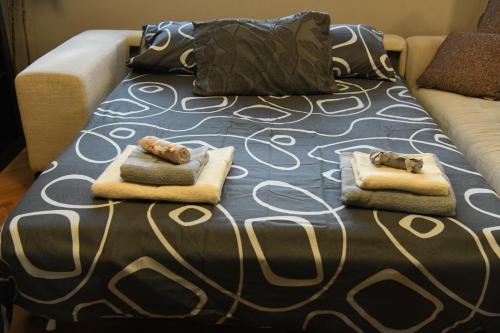 a bed with two animal pillows on top of it at Mustache 3 Room Apt City Center in Bitola