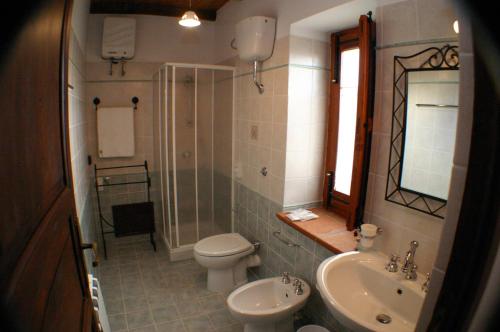 a bathroom with a sink and a toilet and a shower at Il Baglio di Nonna Clelia in Polizzi Generosa