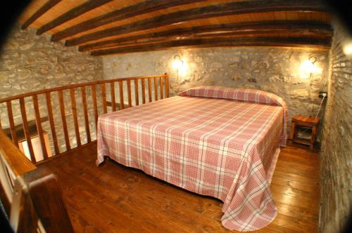 a bedroom with a bed with a checkered blanket at Il Baglio di Nonna Clelia in Polizzi Generosa