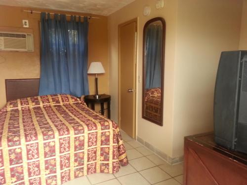 a hotel room with a bed and a television at Atlantic Inn Seaside Heights in Seaside Heights