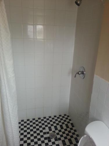 a bathroom with a black and white checkered floor at Atlantic Inn Seaside Heights in Seaside Heights
