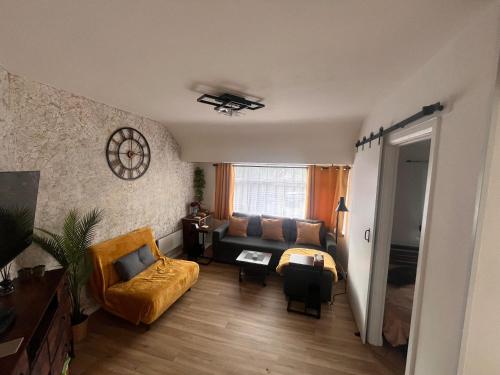 a living room with a couch and a table at Luxury Smart Apartment Slough, Sleeps 5, Garden, Parking, Spa-Style Bathroom in Slough