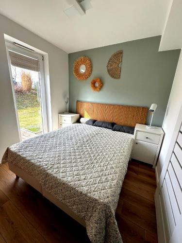 a bedroom with a bed and two mirrors on the wall at Apartament Vespa in Mechelinki