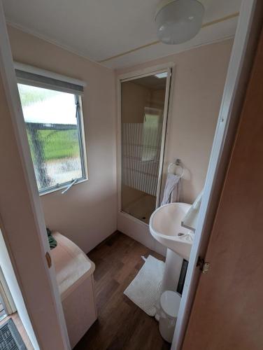 a small bathroom with a sink and a mirror at Casa di Palli in Mariënberg