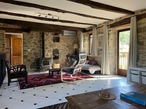 a living room with a couch and a chair and a table at La Sérénité in Najac