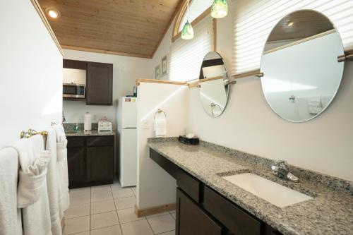 a bathroom with a sink and a refrigerator at The Ocracoke Harbor Inn in Ocracoke