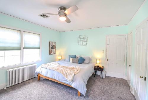 a bedroom with a bed with blue walls and a window at Lofty Elegant Home • Downtown Princeton • 3BR in Princeton