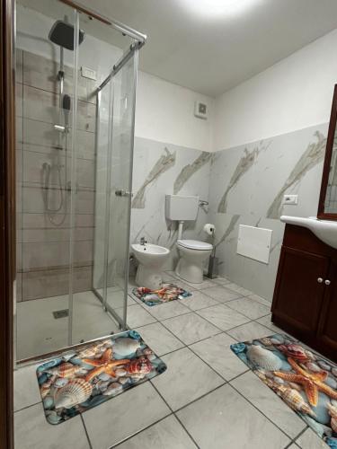 a bathroom with a shower and a toilet at Civico 31 in Terralba