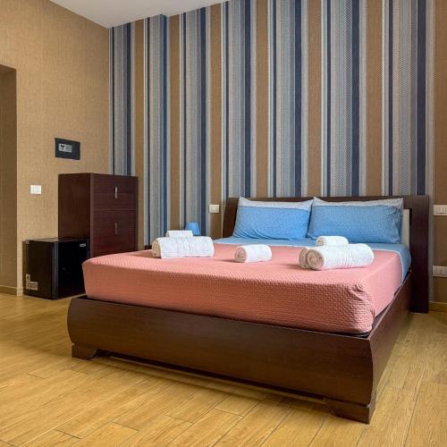 a bedroom with a bed with two towels on it at Edo House Anzio - Beachfront - Fronte Mare - Affittacamere - Private Parking in Anzio