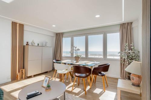 a living room with a table and chairs at The View II Costa Caparica ( private parking ) in Costa da Caparica