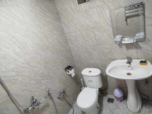 a bathroom with a toilet and a sink at Rest House in Quba