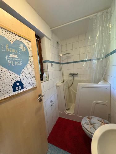 a bathroom with a toilet and a shower and a sink at Ferienwohnung Löffel-Lodge in Heimbach