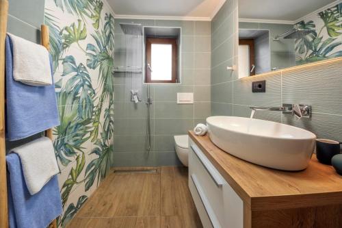 a bathroom with a white sink and a shower at Istrian Perfect Life in Šmarje