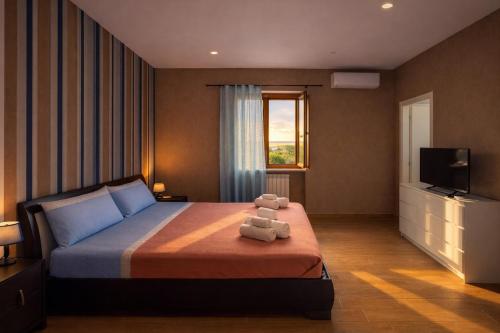 a bedroom with a bed with a teddy bear on it at Edo House Anzio - Beachfront - Fronte Mare - Affittacamere - Private Parking in Anzio