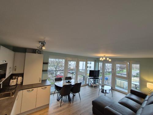 a kitchen and living room with a couch and a table at Fabulous 3 Bedroom Flat in Edinburgh