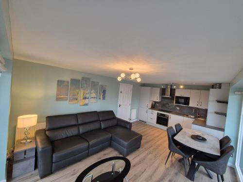 a living room with a couch and a table at Fabulous 3 Bedroom Flat in Edinburgh