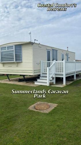 a mobile home with a porch and a park at Belvedere Sleeps 4-6 in Skegness