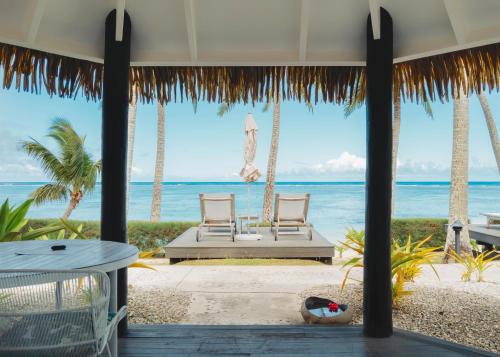 a view of the beach from the porch of a resort at Motu Beachfront Art Villas in Rarotonga