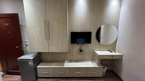 a room with a desk and a tv in a room at Grand Elite Hotel in Cairo