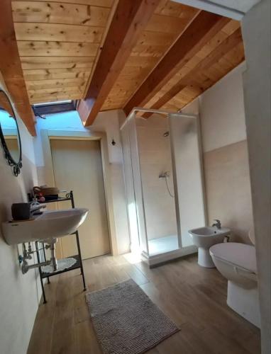 a bathroom with a sink and a toilet and a mirror at L'Armonica di Nonno Sandro in Corfinio