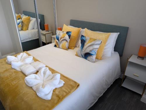 a bedroom with a large white bed with towels on it at Stunning Sea View 2BR Flat Sleeps 5 Walk to Beach - Big Savings for Extended Stays - by Nestora Stays Ltd in Brighton & Hove