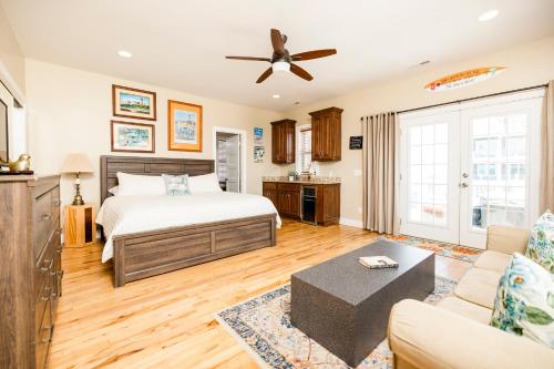 a bedroom with a bed and a couch at Paws and Relax! in Carolina Beach