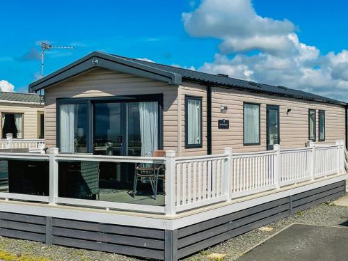 a house with a large deck with a balcony at Bordeaux in Heysham